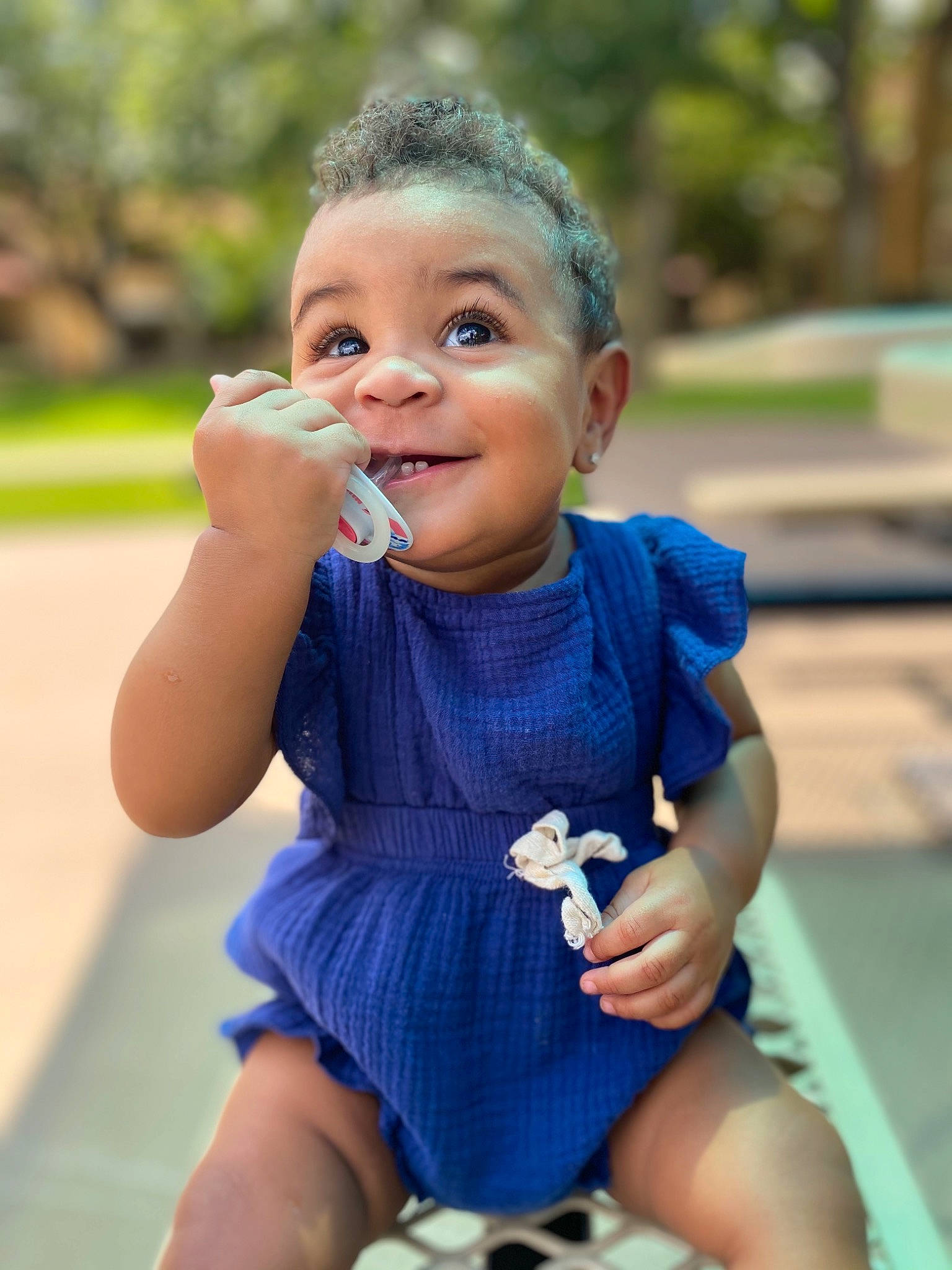 Anyla is registered to the contest to win money with this photo: baby_toddler_clothing, child, electric_blue, finger, fun, gesture, grass, happy, head, iris, leisure, lip, person, public_space, recreation, skin, smile, summer, thigh, thumb