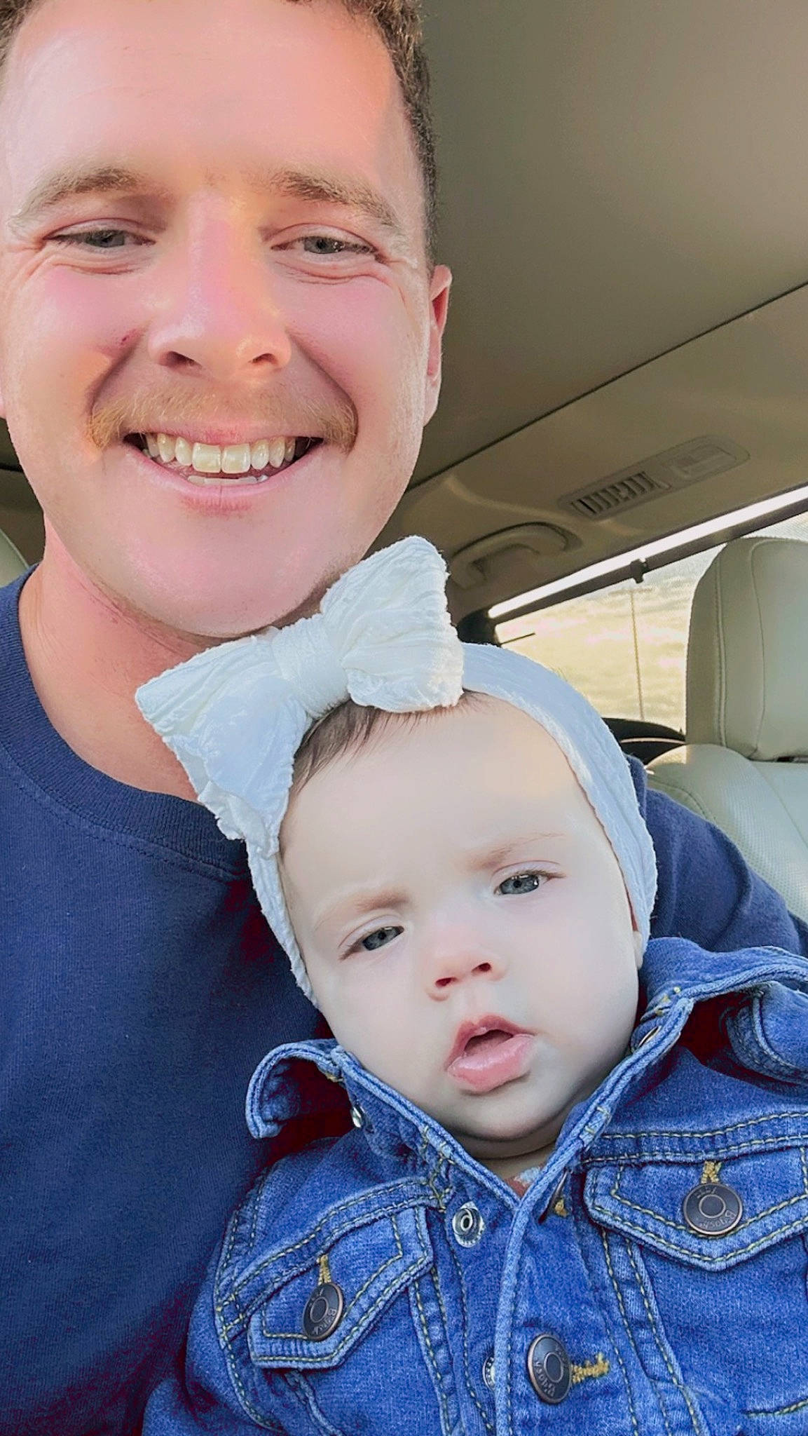 Fiona is registered to the contest to win money with this photo: baby, baby_toddler_clothing, blue, cheek, child, chin, clothing, face, fun, gesture, happy, joy, laugh, lip, nose, person, sitting, skin, smile, toddler