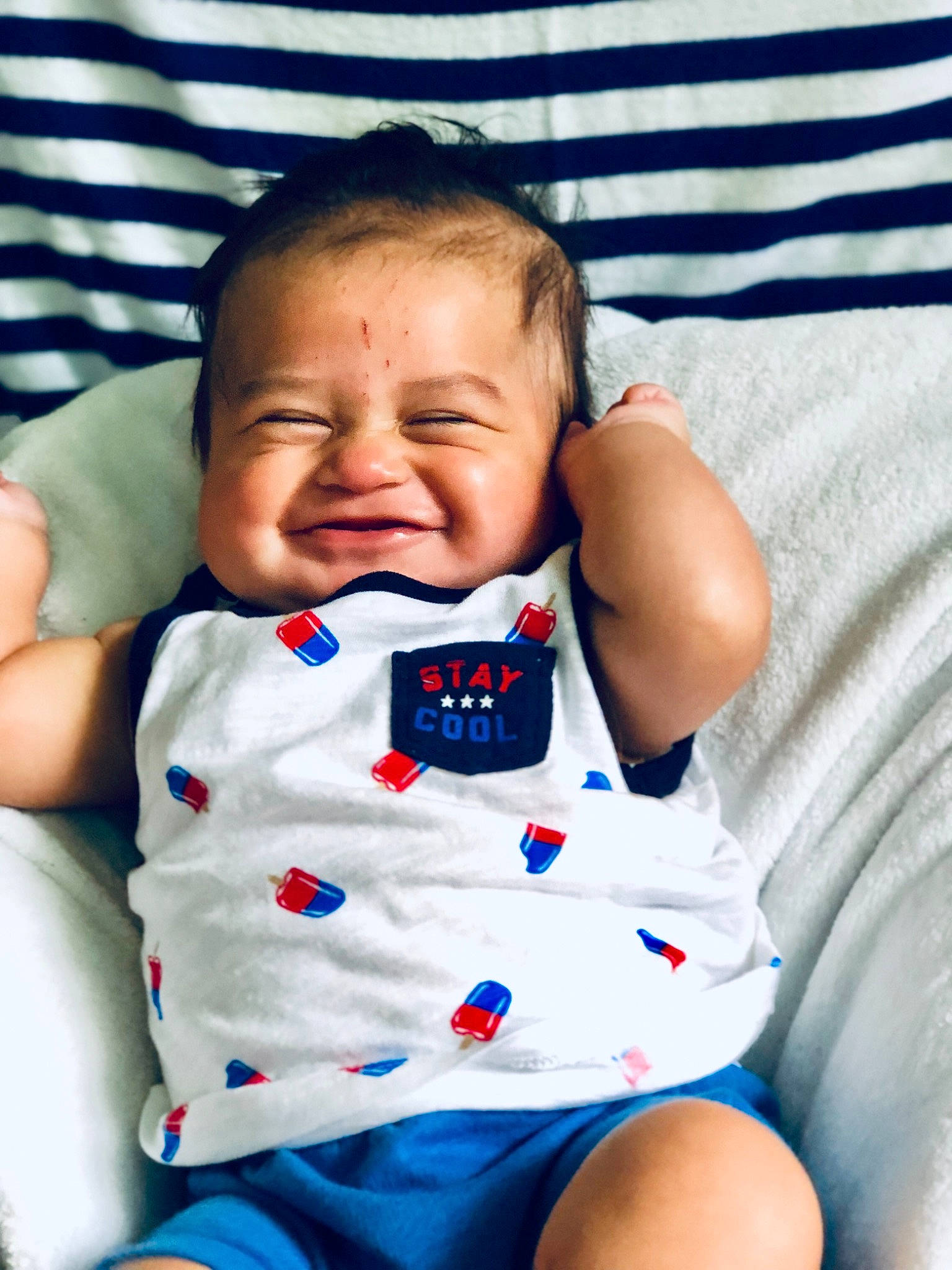 Leroy is registered to the contest to win money with this photo: baby, baby_products, baby_toddler_clothing, cheek, child, facial_expression, mouth, nose, person, sitting, skin, smile, toddler