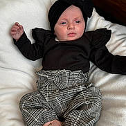 Sienna joined the competition — help win amazing prizes! baby, infant, child, black_headband, black_top, ruffles, checkered_pants, pink_shoes, blanket, white_blanket, soft_texture, lying_down, cute, fashionable, portrait, indoors, comfort, young_child, headwear, footwear