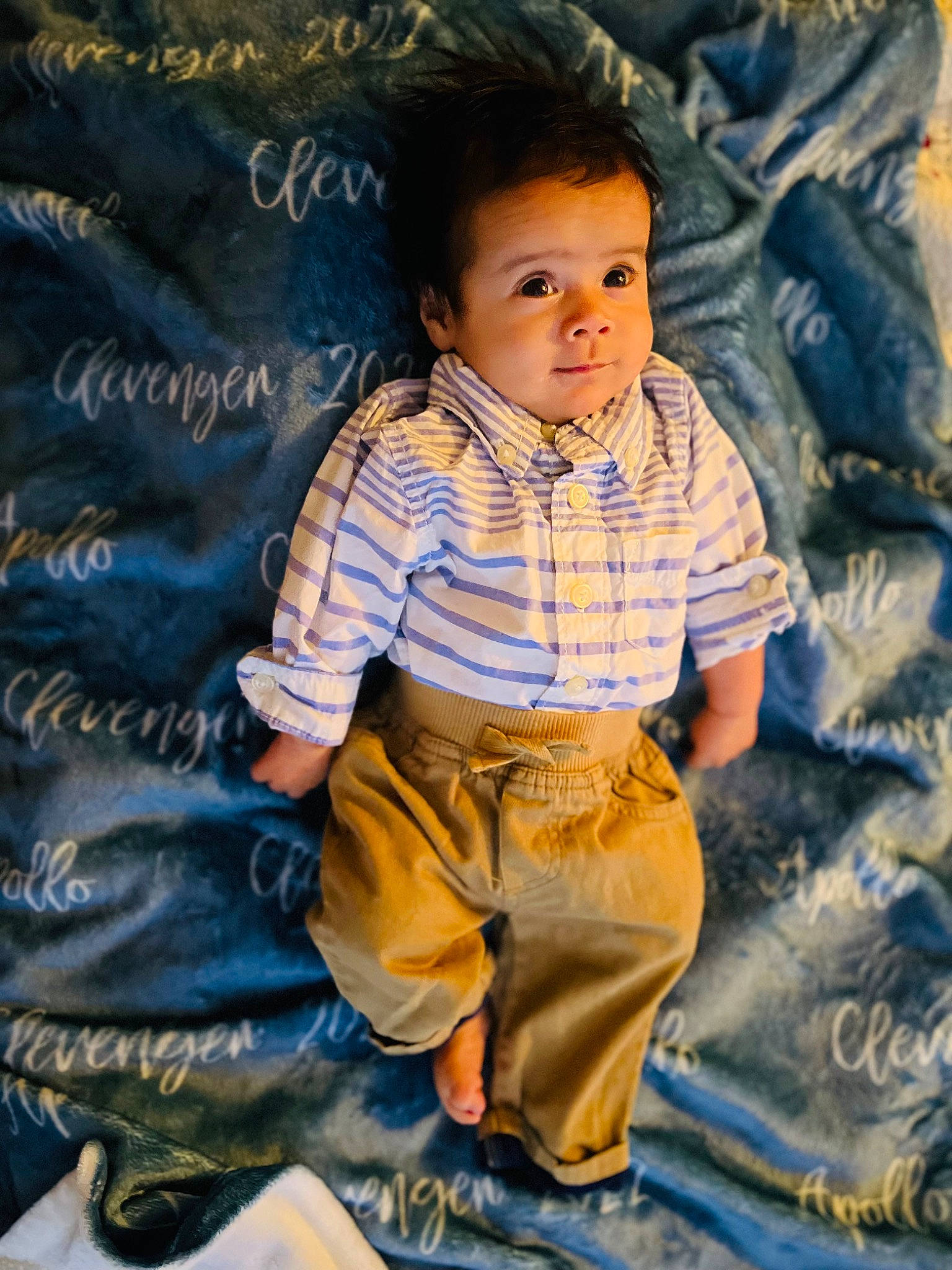 Apollo is registered to the contest to win money with this photo: baby, baby_toddler_clothing, cheek, child, cool, denim, electric_blue, eye, fun, happy, linens, pattern, people_in_nature, person, plaid, sitting, skin, sleeve, t_shirt, toddler