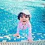 blue_water, child, curly_hair, fun, hands, happy, hat, leisure, outdoor, person, playful, pool, recreation, smiling, splash, summer, swimsuit, tile, toddler, water