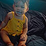 Maylee is registered to the contest to win money with this photo: toddler, child, smiling, yellow_outfit, bow_headband, sitting, bed, indoors, happy, cute, baby, footwear, portrait, young_child, person, clothing, dim_lighting, expression, skin, face
