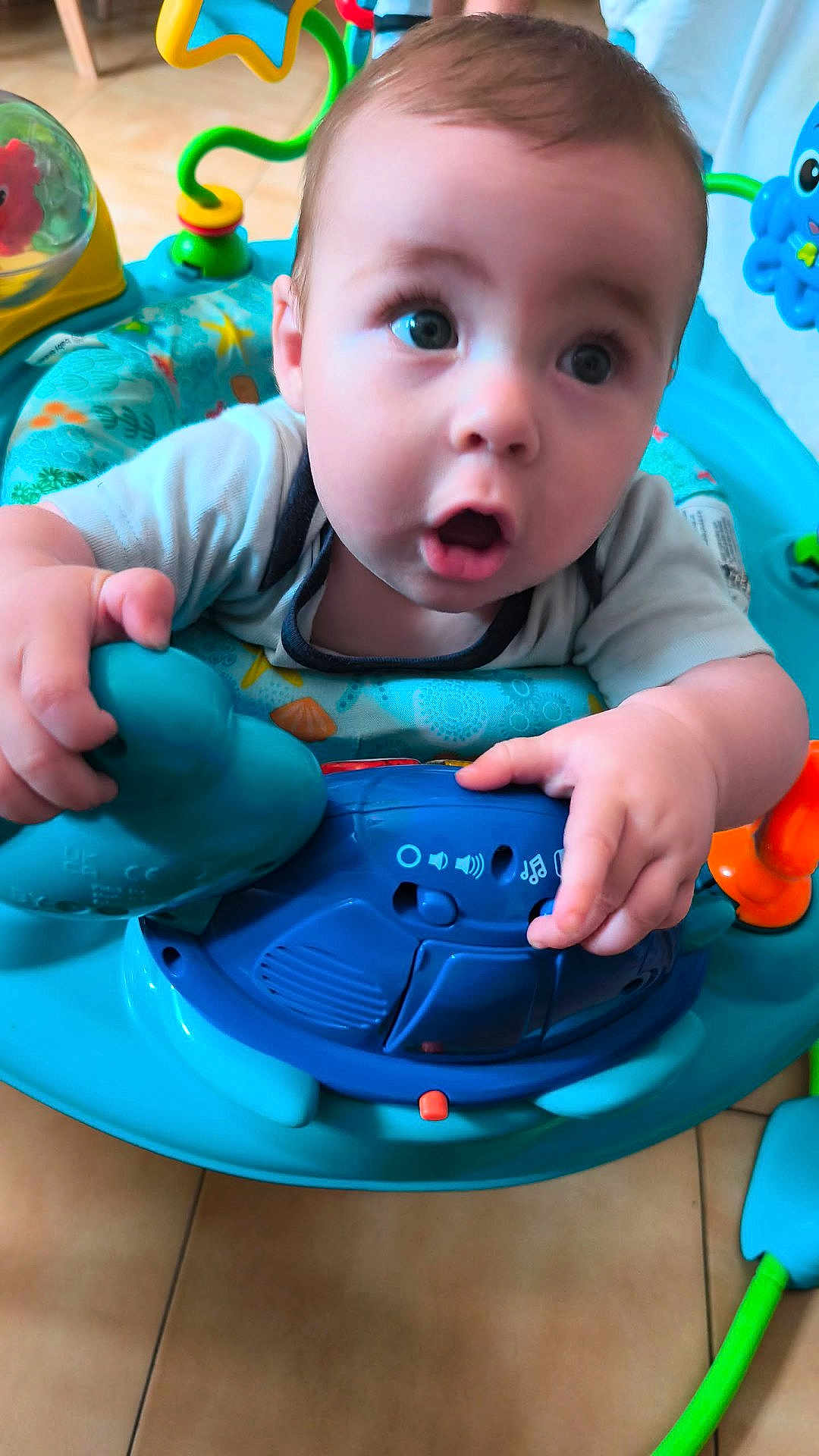 Melyo participe au concours pour gagner de l'argent avec cette photo : baby, child, infant, toy, activity_center, blue, play, curious, indoor, floor, colorful, plastic, hand, face, expression, closeup, seat, crawling, person, young