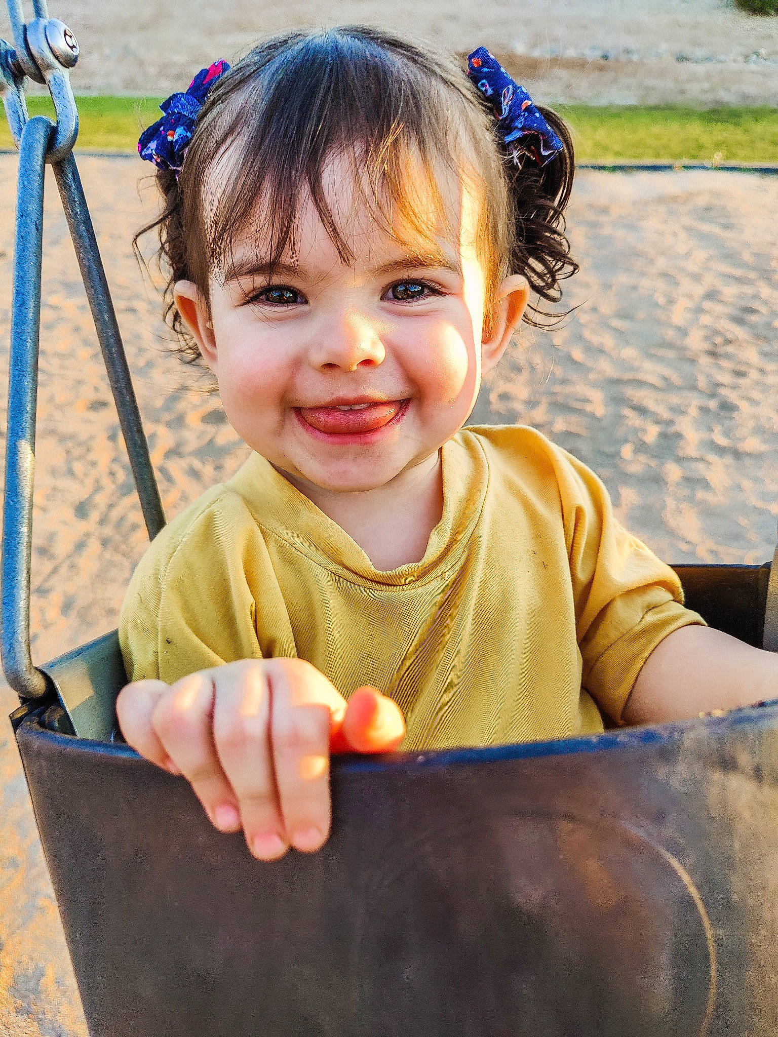 Quinn is registered to the contest to win money with this photo: arm, blue, eye, facial_expression, finger, gesture, grass, hair, hairstyle, hand, happy, head, joy, leisure, organ, people_in_nature, person, public_space, skin, smile