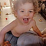 bare_chest, child, couch, curly_hair, family, footwear, furniture, happy, home, indoor, living_room, person, photography, plant, playful, smiling, tile_floor, toddler, tongue_out, toy_car