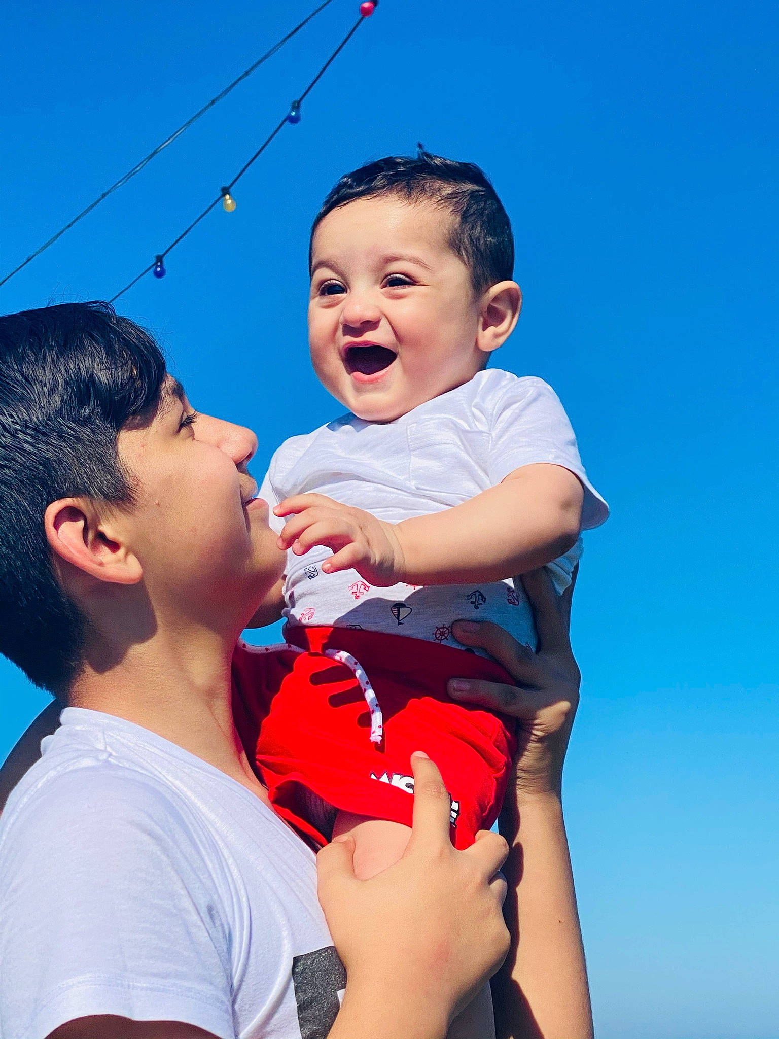 Andrei is registered to the contest to win money with this photo: azure, baby, baby_toddler_clothing, eye, facial_expression, flash_photography, gesture, happy, human_body, interaction, leisure, mouth, muscle, people_in_nature, person, shorts, skin, sky, smile, summer