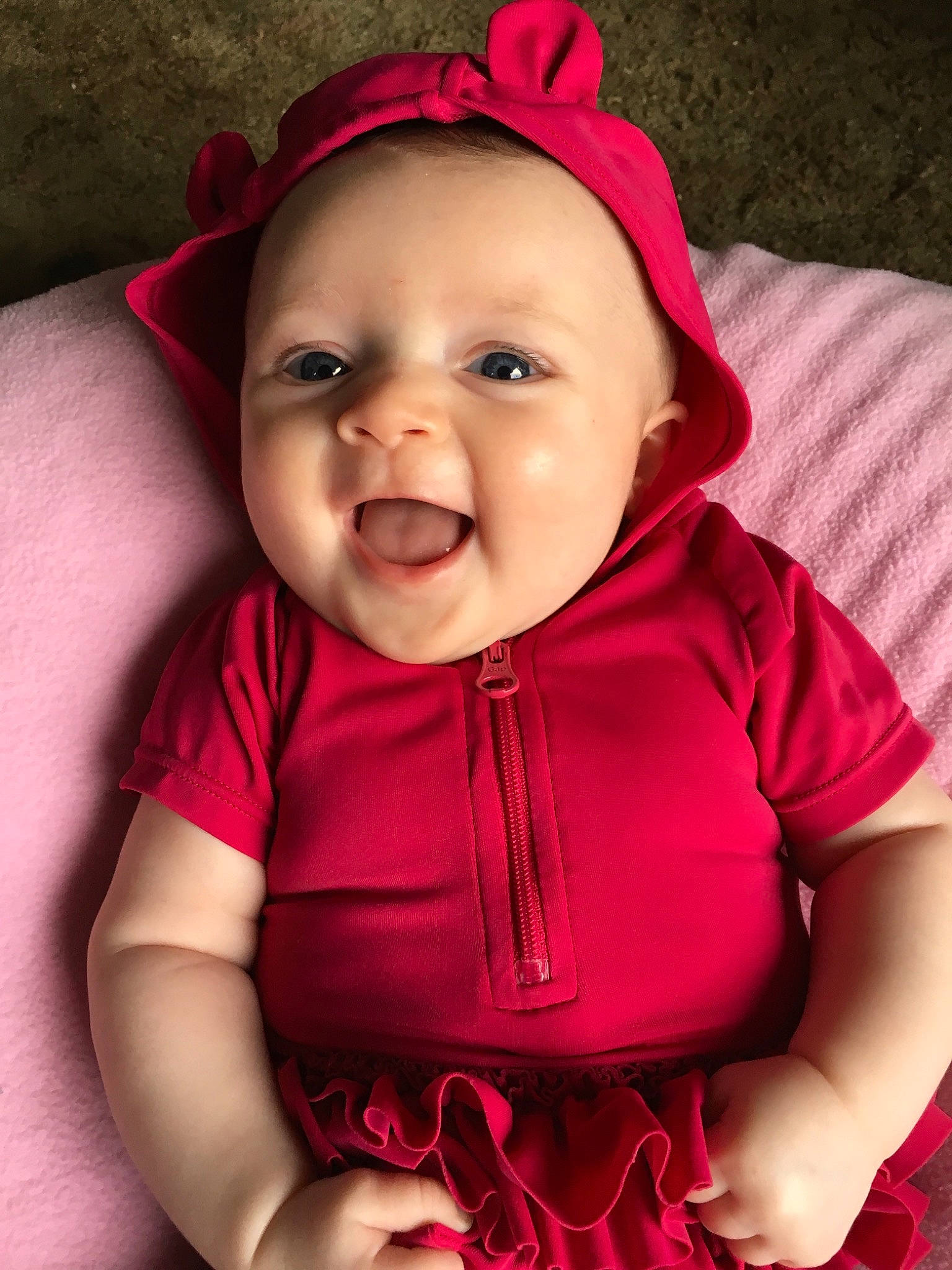 Rosalee is registered to the contest to win money with this photo: baby, cheek, child, child_model, face, facial_expression, fun, happy, head, headgear, joy, laugh, lip, mouth, nose, person, pink, product, red, skin