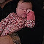 baby, sleeping, floral_onesie, infant, tattoo, arm, adult, close_up, indoor, portrait, peaceful, resting, child, person, skin, hand, clothing, holding, cute, newborn