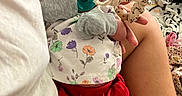 Isabella joined the competition — help win amazing prizes! baby, bed, blanket, clothing, colorful, comfort, curly_hair, floral_pattern, holding, indoor, infant, mittens, newborn, pacifier, person, plush_toy, red_shorts, resting, socks, soft_lighting