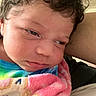 Isabella joined the competition — help win amazing prizes! baby, newborn, closeup, face, curly_hair, blanket, sleepy, infant, skin, person, portrait, cozy, cute, child, indoors, soft, colorful, warm, young, expression
