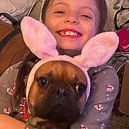 Finnagin joined the competition — help win amazing prizes! child, dog, bunny_ears, costume, hug, smile, indoor, pet, cute, funny, animal, happy, brown_dog, pink, ears, clothing, carpet, home, person, playful