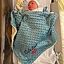 Cristiano participe au concours pour gagner de l'argent avec cette photo : newborn, baby, blanket, blue_blanket, crib, bassinet, bunny_toy, pacifier, hospital, infant, wrapped, cute, sleeping, soft_toy, person, baby_hat, bed, baby_clothes, nursery, cozy