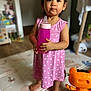 Mia a rejoint le concours — aidez-le/la à gagner de superbes lots ! toddler, child, pink_dress, bottle, indoor, barefoot, toy, orange_toy, playmat, standing, cute, person, young_child, hair_pigtails, home, floor, expression, holding, baby, clothing