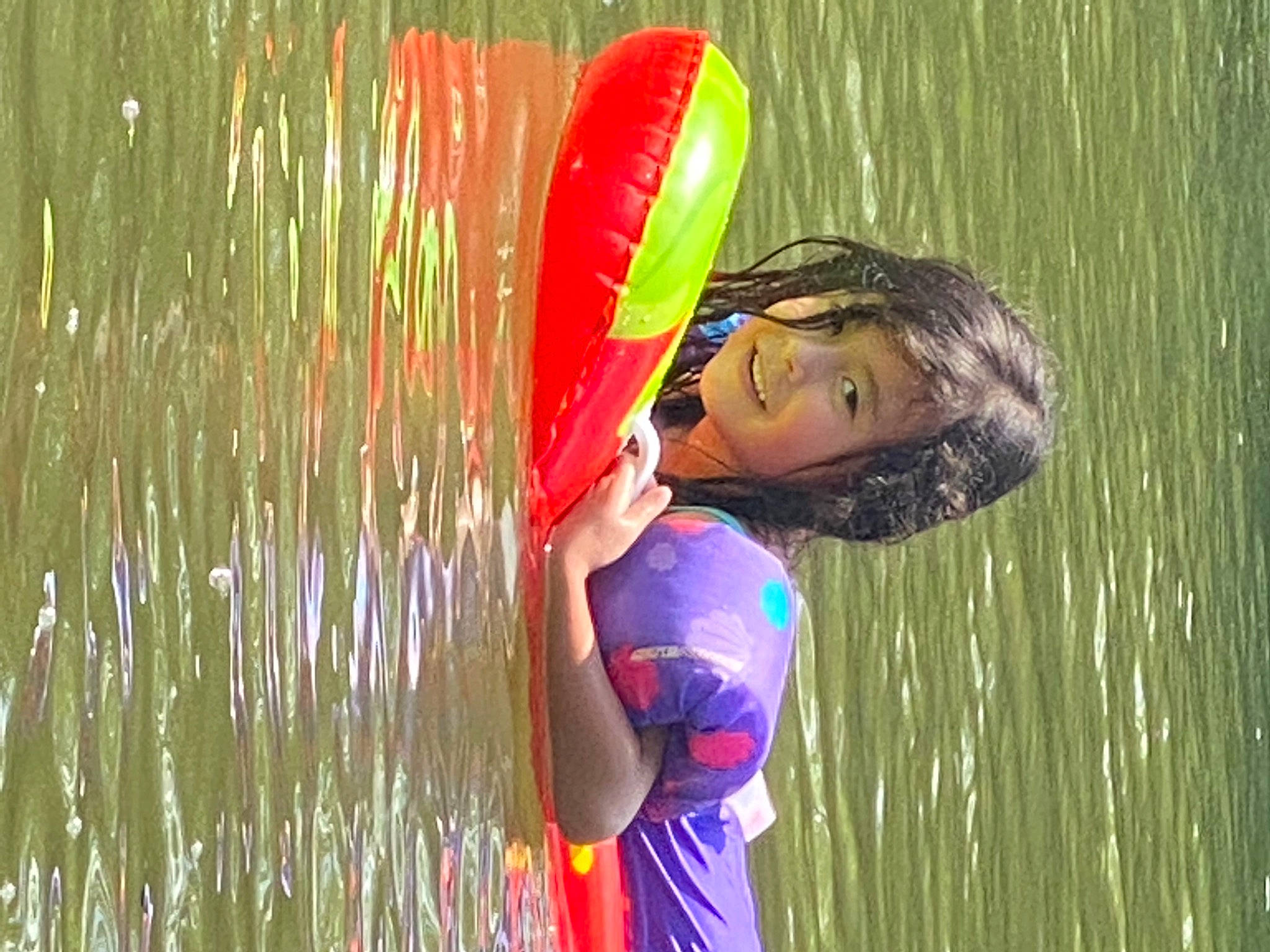 Aiva is registered to the contest to win money with this photo: body_of_water, child, competition_event, flash_photography, fun, grass, grass_family, happy, human_body, joy, lake, leisure, outdoor_recreation, people_in_nature, person, personal_protective_equipment, play, recreation, reflection, swimwear