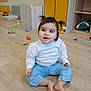 Naomi participe au concours pour gagner de l'argent avec cette photo : baby, toddler, child, sitting, playroom, toys, wooden_floor, pigtails, smile, cheeks, white_sweater, blue_pants, bare_feet, cabinet, storage, indoor, happy, floor_toys, playtime, portrait