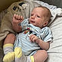 baby, infant, clothing, onesie, socks, blanket, soft, cute, lying_down, portrait, child, mickey_mouse, yellow, blue, striped, fist, face, head, indoors, pacifier
