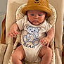 Mariano participe au concours pour gagner de l'argent avec cette photo : apparel, arms, baby, baby_seat, bear_hat, bear_onesie, child, clothing, comfort, cushion, cute, expression, footwear, headwear, indoors, infant, legs, person, portrait, skin