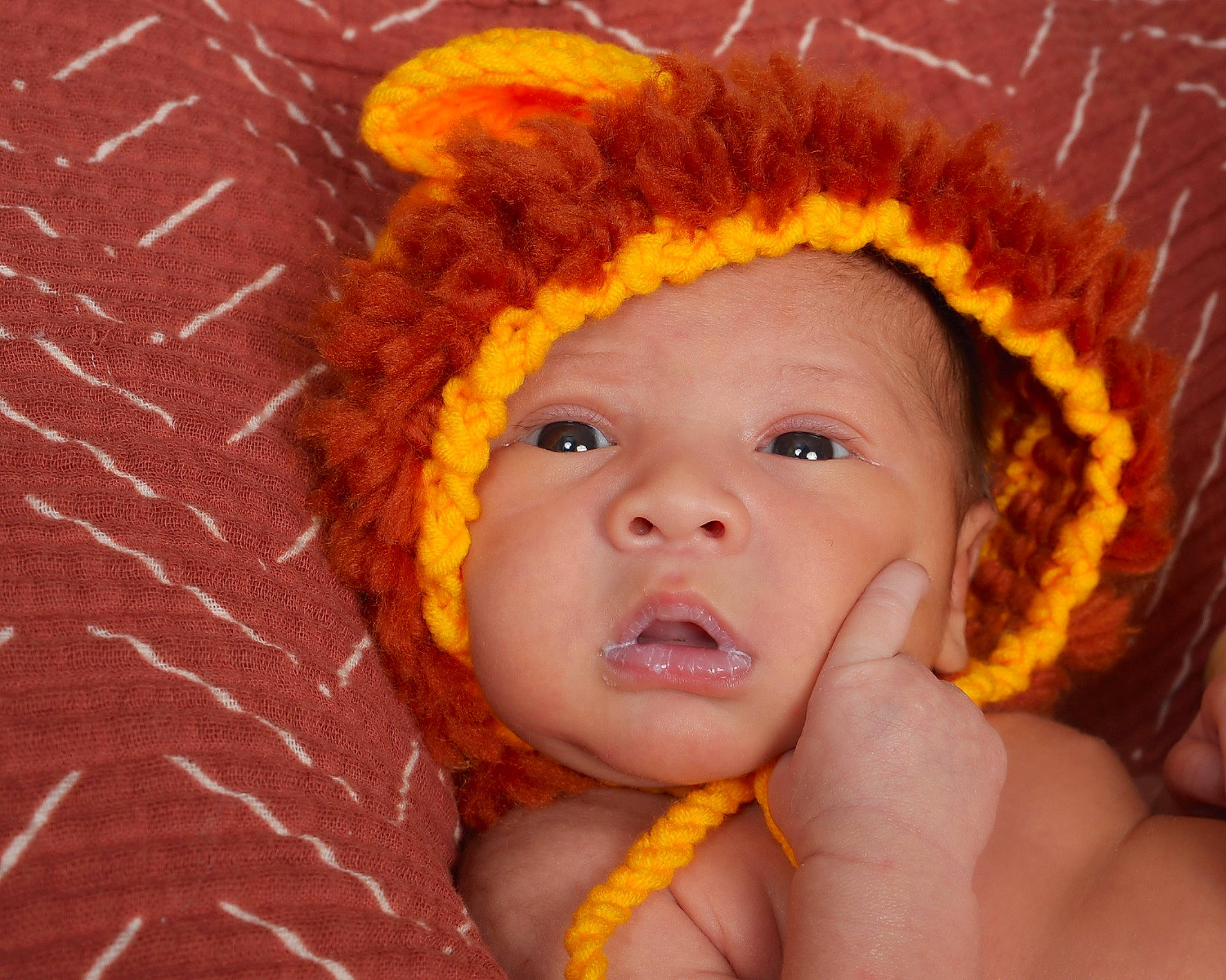 Khalil is registered to the contest to win money with this photo: baby, cap, cheek, eyebrow, eyelash, finger, gesture, hand, happy, headgear, headwear, iris, lip, mouth, nose, orange, organ, person, pink, skin