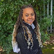 Kimberly is registered to the contest to win money with this photo: child, smiling, braided_hair, blonde_ombre, black_jacket, outdoor, greenery, leaves, fence, happy, portrait, person, fashion, nature, curly_hair, standing, young, casual_wear, daylight, park