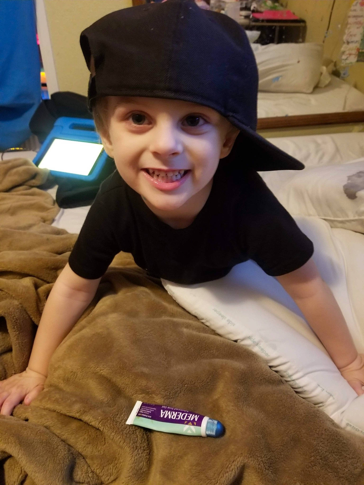 Nico joined the competition — help win amazing prizes! baseball_cap, beanie, cap, child, flooring, forehead, fun, gesture, hairstyle, headgear, headwear, hoodie, joy, knit_cap, linens, person, personal_protective_equipment, room, sleeve, smile