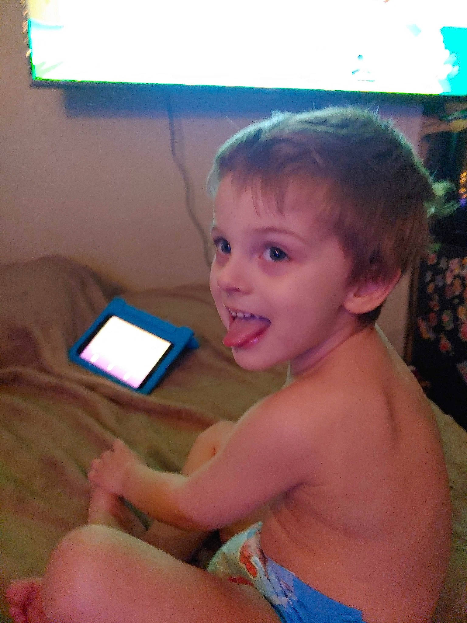 Nico is registered to the contest to win money with this photo: chest, child, communication_device, finger, fun, gesture, hand, happy, human_body, leisure, mobile_device, muscle, neck, person, skin, smile, tablet_computer, television, thigh, thumb