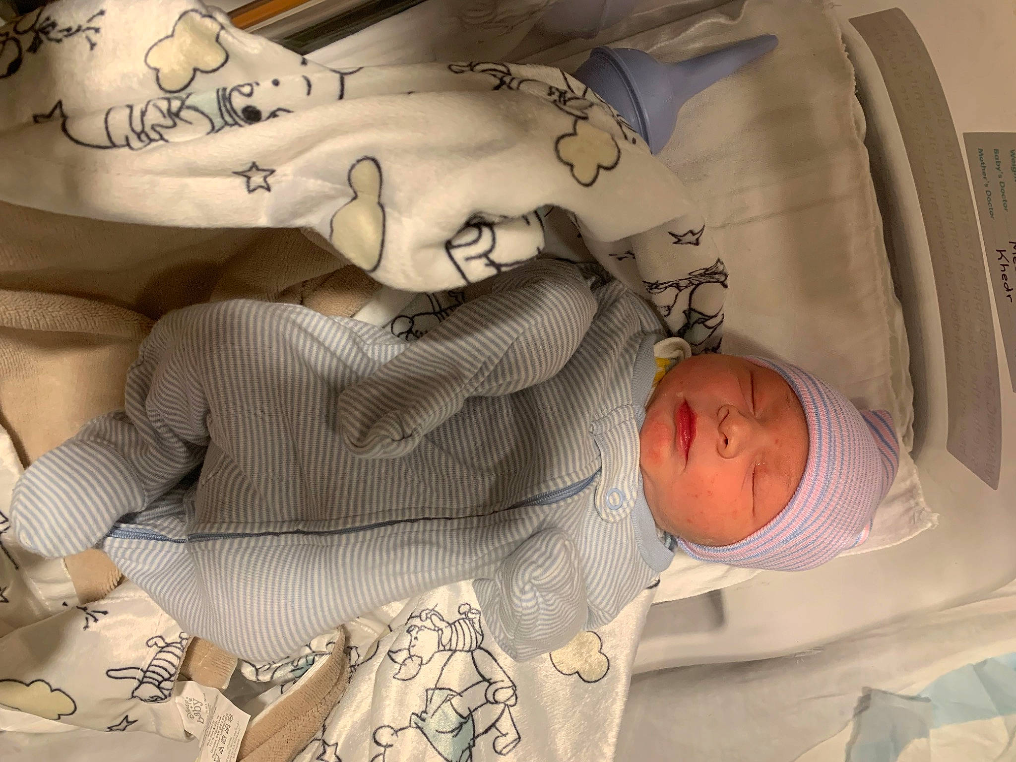 Graysen is registered to the contest to win money with this photo: arm, art, baby, baby_sleeping, child, comfort, facial_expression, finger, gesture, glasses, hand, happy, headwear, human, infant_bed, linens, mouth, pattern, person, skin