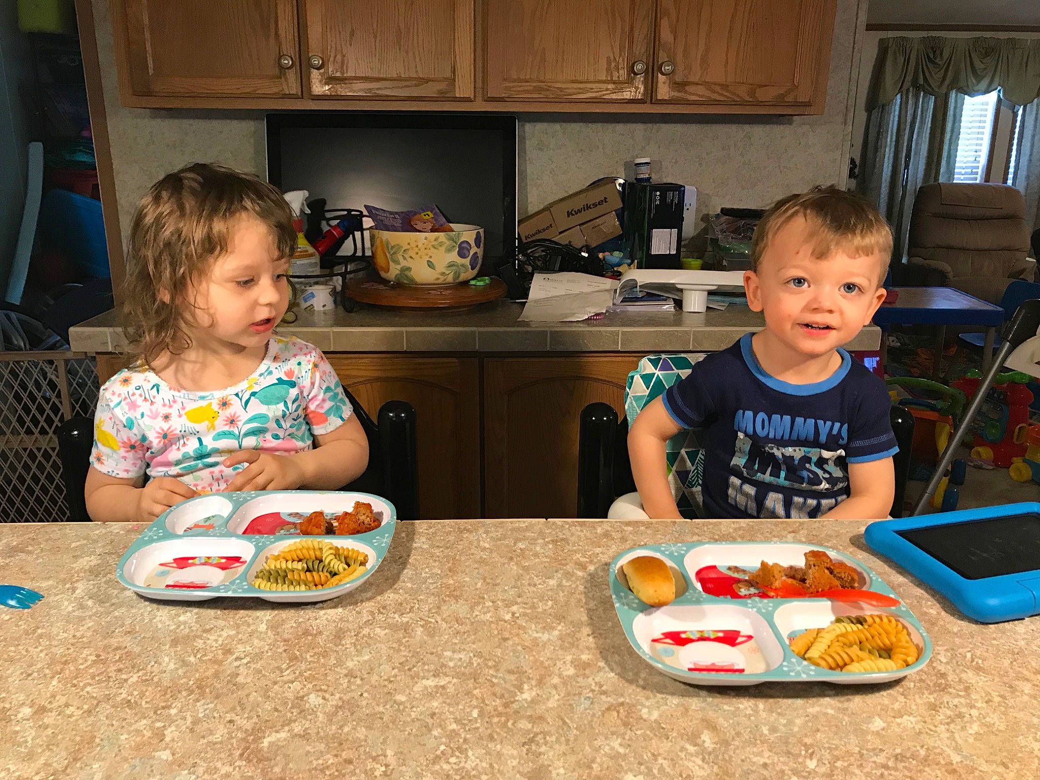 Michael Jr is registered to the contest to win money with this photo: cabinetry, chair, cooking, countertop, curtain, event, food, fun, furniture, home_appliance, joy, kitchen, kitchen_appliance, person, play, room, sharing, sitting, t_shirt, table