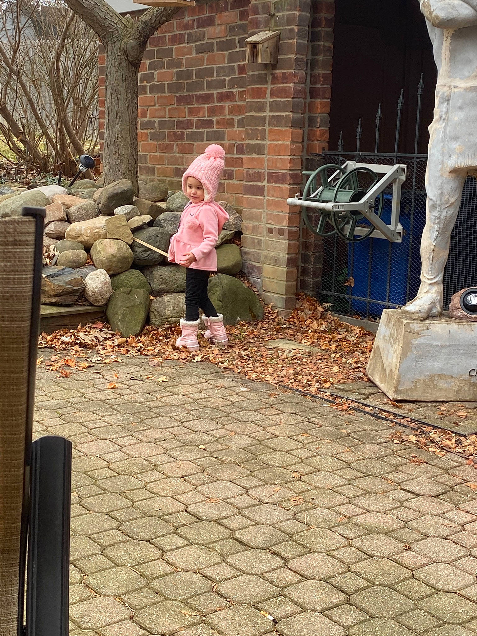 Maria joined the competition — help win amazing prizes! backyard, cobblestone, grass, headwear, home, house, landscaping, person, plant, road_surface, sitting, tree, winter, wood, yard