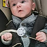 baby, bundle, button, car_seat, child, clothing, cute, expression, eyes, fabric, face, hand, indoor, infant, person, portrait, safety, seatbelt, sitting, young