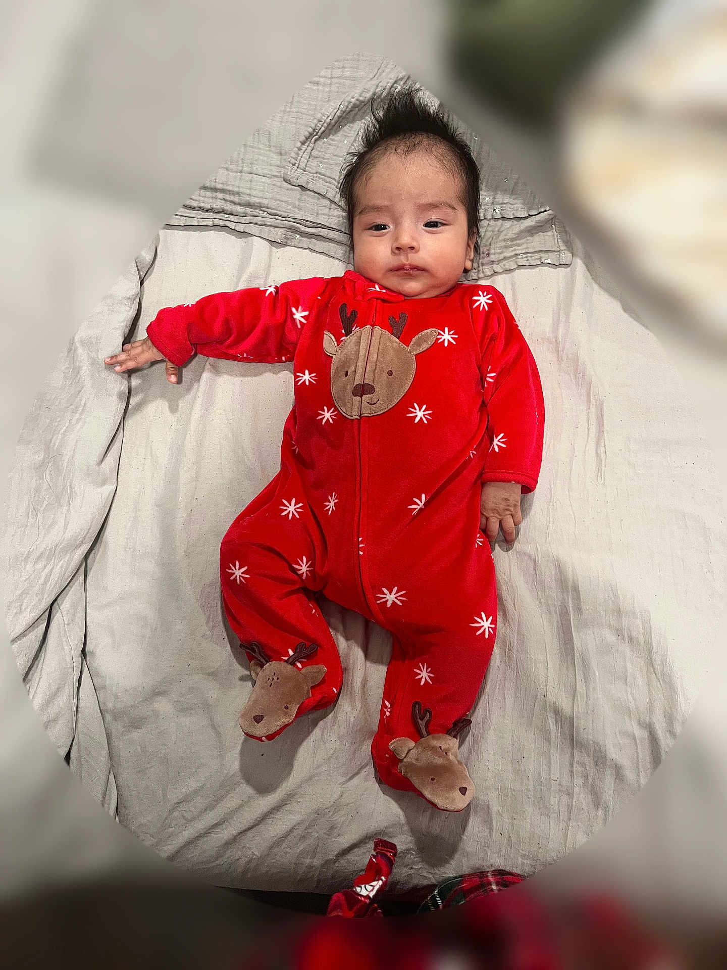 Lucca joined the competition — help win amazing prizes! baby, infant, red_onesie, reindeer_pattern, footed_pajamas, blanket, lying_down, indoor, cute, child, portrait, newborn, cozy, soft_fabric, clothing, person, face, hair, expression, holiday_theme