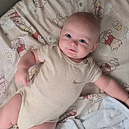 Colby joined the competition — help win amazing prizes! baby, infant, child, smiling, lying_down, portrait, face, eyes, onesie, clothing, blanket, changing_mat, nursery, indoor, cartoon_pattern, winnie_the_pooh, cushion, relaxed, happy, photography