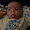 Kayson is registered to the contest to win money with this photo: animal, applique, baby, bed, blanket, bodypart, clothing, face, finger, furniture, hand, head, newborn, person, photography, portrait, reptile, sealife, t_shirt, turtle
