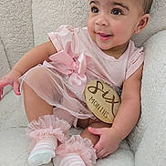 Erin joined the competition — help win amazing prizes! adorable, armchair, baby, child, curly_hair, cute, earrings, fluffy, happy, indoors, infant, pigtails, pink_clothing, portrait, sitting, six_months, smiling, socks, soft_texture, tutu