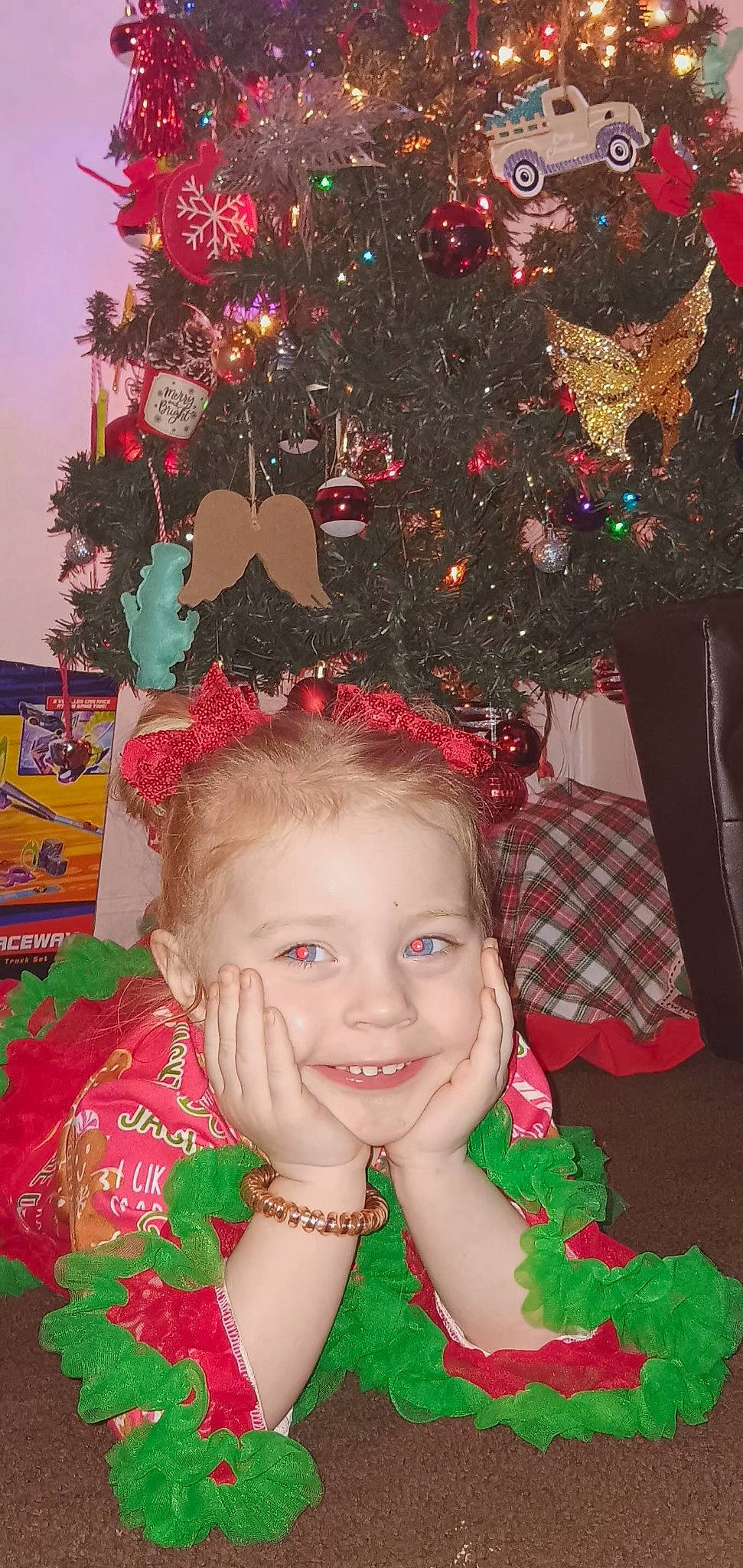 Cecilia is registered to the contest to win money with this photo: christmas, christmas_decoration, christmas_eve, christmas_ornament, christmas_tree, event, fun, green, happy, holiday, holiday_ornament, human_body, joy, leaf, person, pink, plant, red, smile, toddler