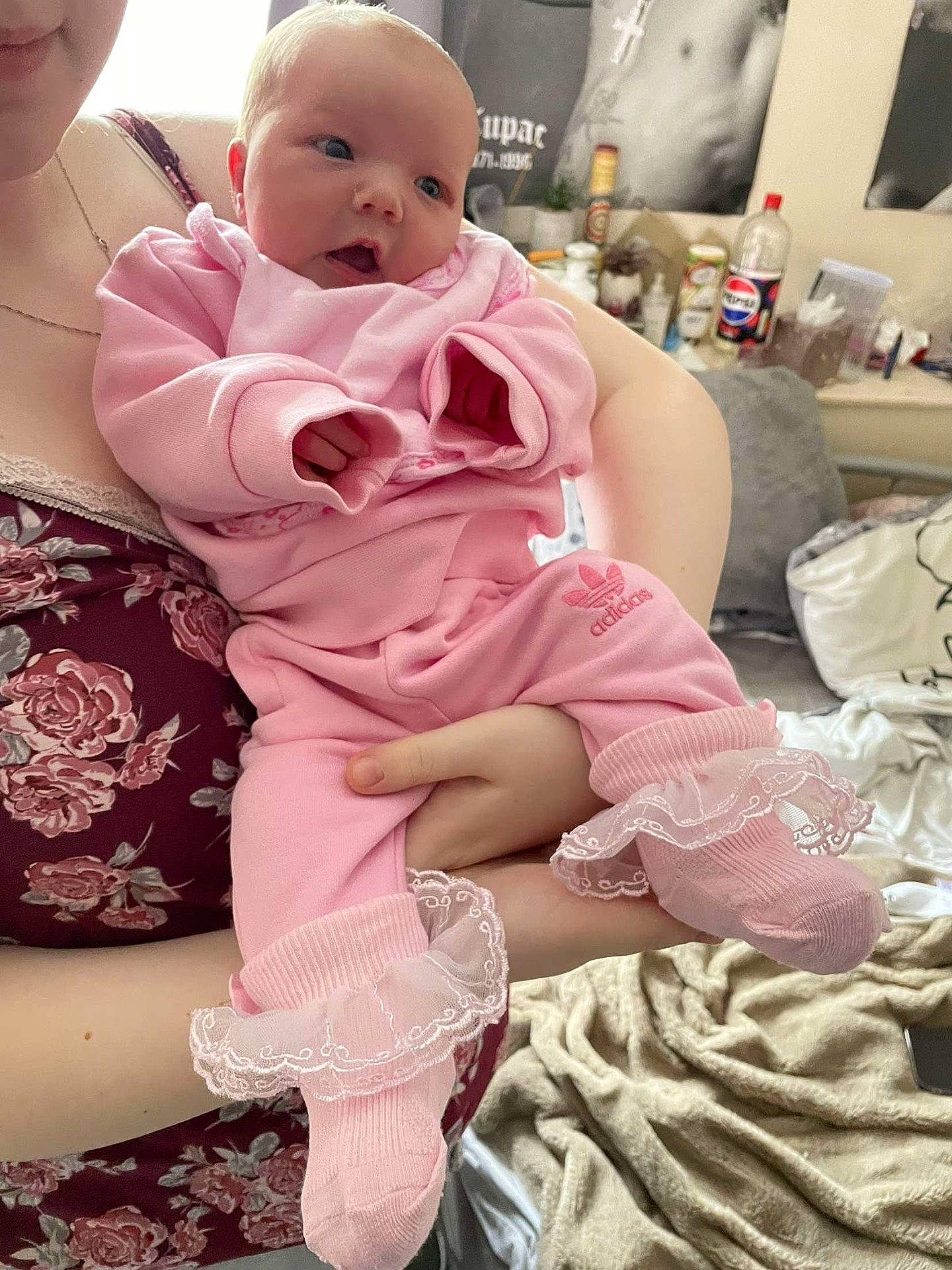 Everleigh is registered to the contest to win money with this photo: accessories, baby, blanket, clothing, cup, dress, face, head, jewelry, necklace, newborn, pants, pen, people, person, photography, portrait, shorts, sitting, sleeve