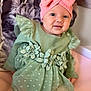 baby, cat_pillow, child, cute, face, floral_design, green_dress, happy, headband, indoor, infant, person, pillow, pink_bow, polka_dot, portrait, seated, smiling, soft_fabric, tulle