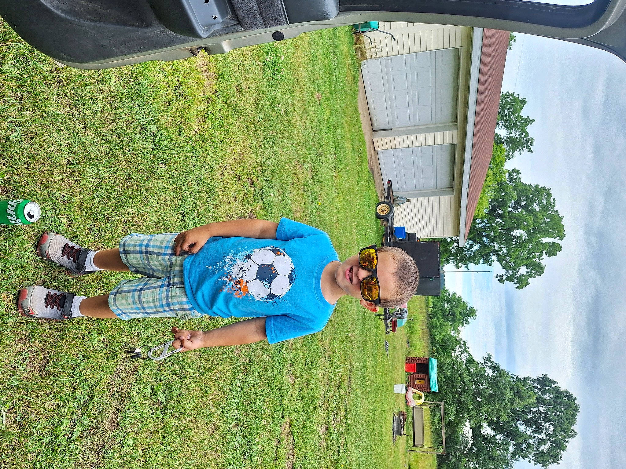 Brodie joined the competition — help win amazing prizes! child, electric_blue, fun, grass, green, human_leg, landscape, lawn, leisure, line, people_in_nature, person, plant, recreation, shorts, sky, t_shirt, toddler, tree, vehicle_door