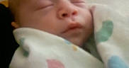 Liam is registered to the contest to win money with this photo: newborn, baby, infant, sleeping, sleepy, face, portrait, blanket, swaddled, wrapped, indoors, home, close_up, peaceful, resting, soft_lighting, blurred, cozy, pastel, child
