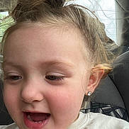 Amelia joined the competition — help win amazing prizes! child, toddler, face, smiling, happy, earrings, hair, messy_bun, inside_car, seat, window, natural_light, closeup, person, cute, joyful, skin, eyelashes, mouth_open, casual_clothing