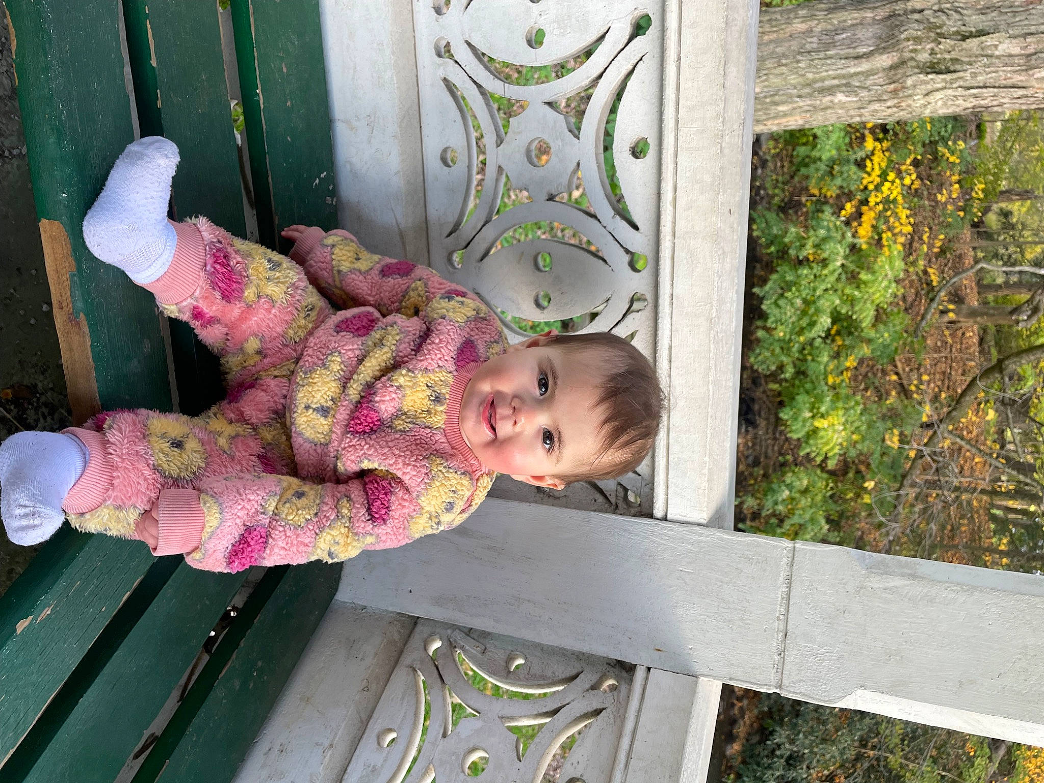 Aeris is registered to the contest to win money with this photo: baby, baby_products, baby_toddler_clothing, child, grass, green, magenta, pattern, people_in_nature, person, plant, sitting, toddler, tree, twig, wood