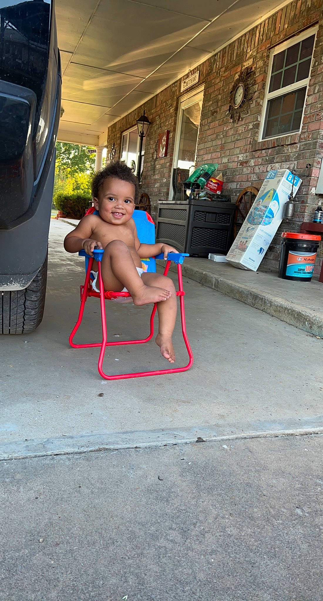 Asher is registered to the contest to win money with this photo: asphalt, barefoot, chair, concrete, electric_blue, flooring, foot, fun, human_body, human_leg, joy, leg, leisure, person, recreation, road_surface, shoulder, sidewalk, street, t_shirt