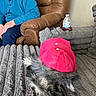 animal, brown_leather_recliner, casual, clothing, comfort, cozy, dog, furniture, gray_blanket, home, indoor, man, partial_face, pet, pink_jacket, relaxation, resting, seated, texture, water_bottle