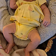 Ellie is registered to the contest to win money with this photo: baby, sleeping, yellow_outfit, blanket, soft_texture, infant, peaceful, cozy, resting, child, cushion, comfort, indoors, cute, small, skin, hand, foot, portrait, relaxation