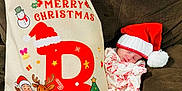 Blakely joined the competition — help win amazing prizes! baby, infant, sleeping, santa_hat, christmas_pajamas, christmas, holiday, pillow, couch, reindeer, santa_claus, christmas_tree, festive, cozy, indoor, cute, child, sleep, celebration, holiday_decor