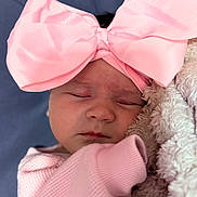 Blakely is registered to the contest to win money with this photo: baby, sleeping, pink_bow, blanket, cozy, infant, cute, soft_texture, headwear, closed_eyes, portrait, child, adorable, warm, sleep, newborn, clothing, face, peaceful, rest