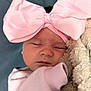 baby, sleeping, pink_bow, headband, blanket, soft_texture, cozy, infant, cute, closed_eyes, pink_clothing, newborn, resting, portrait, child, adorable, warm, snuggled, face, peaceful