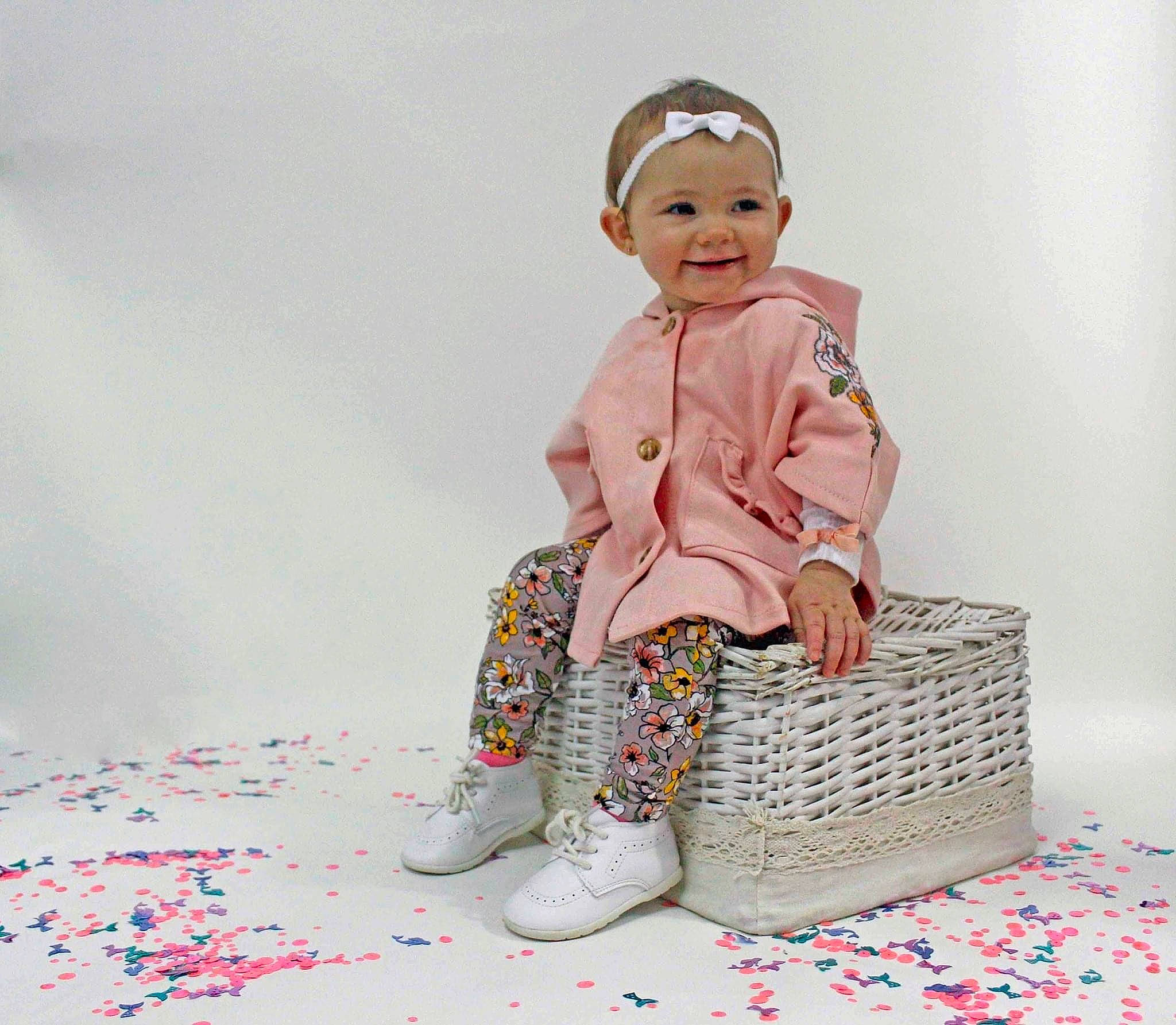 Annaliese is registered to the contest to win money with this photo: art, baby, baby_toddler_clothing, cap, carmine, child, costume_hat, doll, fashion_accessory, fashion_design, figurine, happy, joy, magenta, pattern, peach, person, sitting, sleeve, smile
