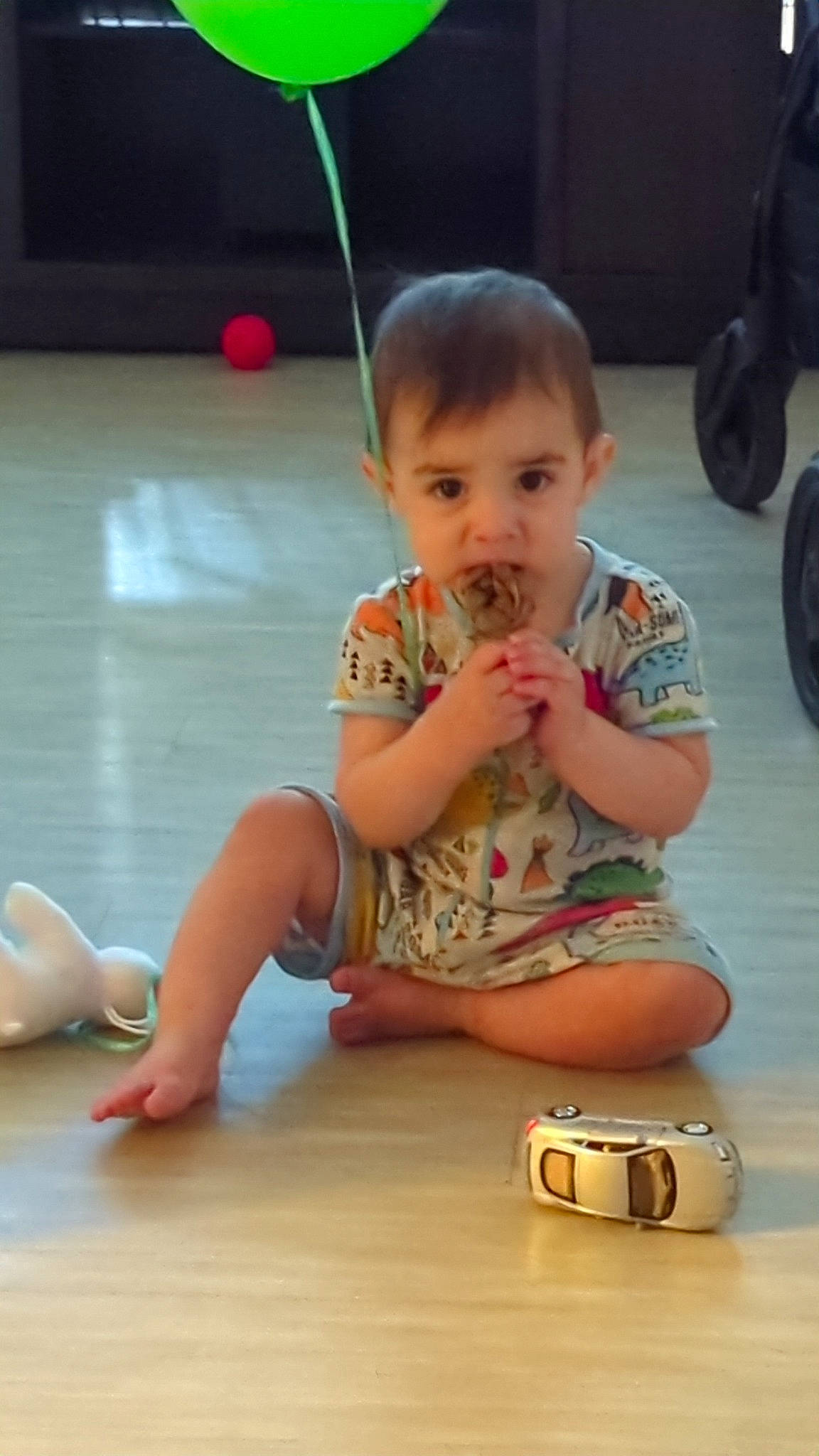 Ezio is registered to the contest to win money with this photo: baby, child, facial_expression, finger, floor, flooring, fun, hand, happy, hardwood, human_leg, joint, leg, leisure, person, skin, thumb, tire, toddler, wheel