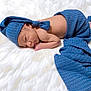 baby, newborn, sleeping, blue_hat, knitted_blanket, white_rug, fur_rug, infant, swaddle, peaceful, portrait, studio, cozy, soft_texture, hand, face, skin, toes, lying_down, blanket